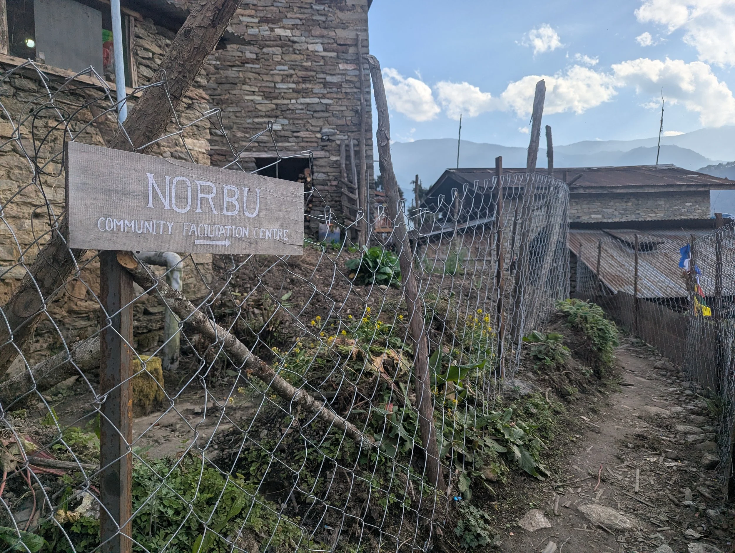 Signpost for the Norbu Community Facilitation Centre in Arunachal Pradesh, the base for the Norbu Governance Futures project by Lagori Collective and It's All Folk with the Brokpa community.