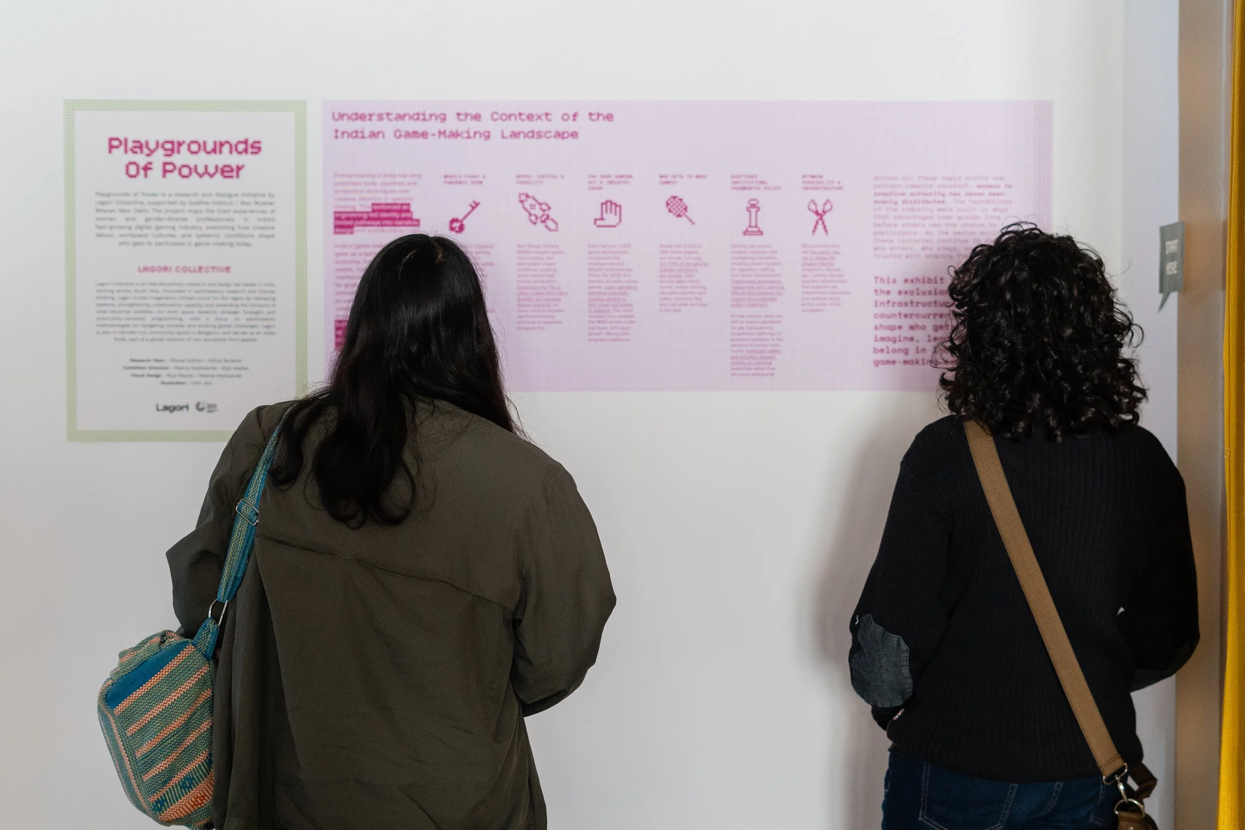 Visitors reading the Playgrounds of Power exhibition panel on understanding the Indian game-making landscape, produced by Lagori Collective and Goethe-Institut.