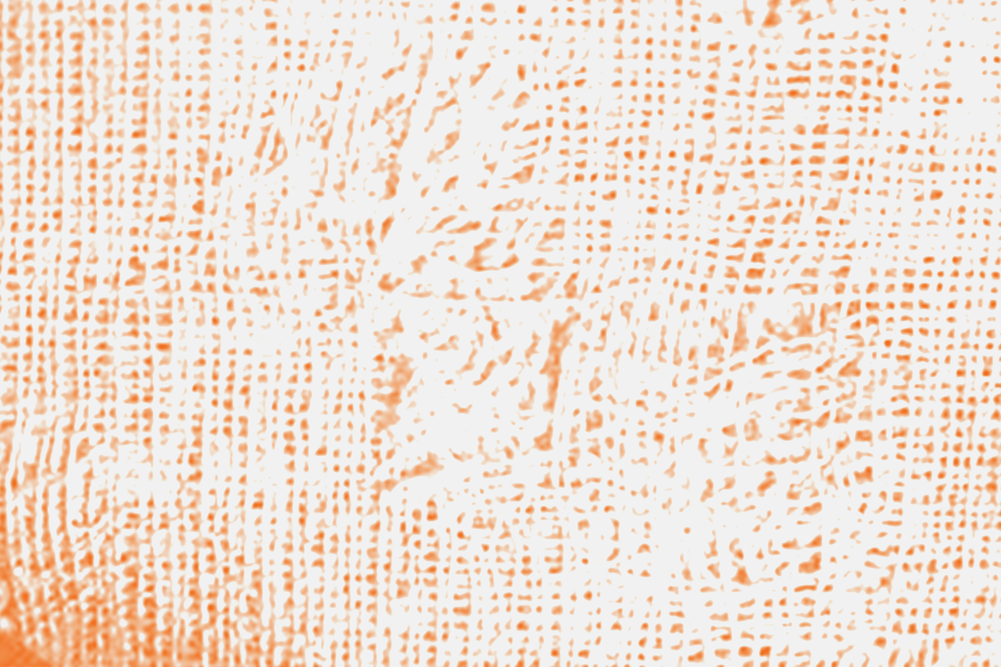 Close-up of a printed pattern with orange ink on white paper, featuring tiny, irregular shapes and lines.