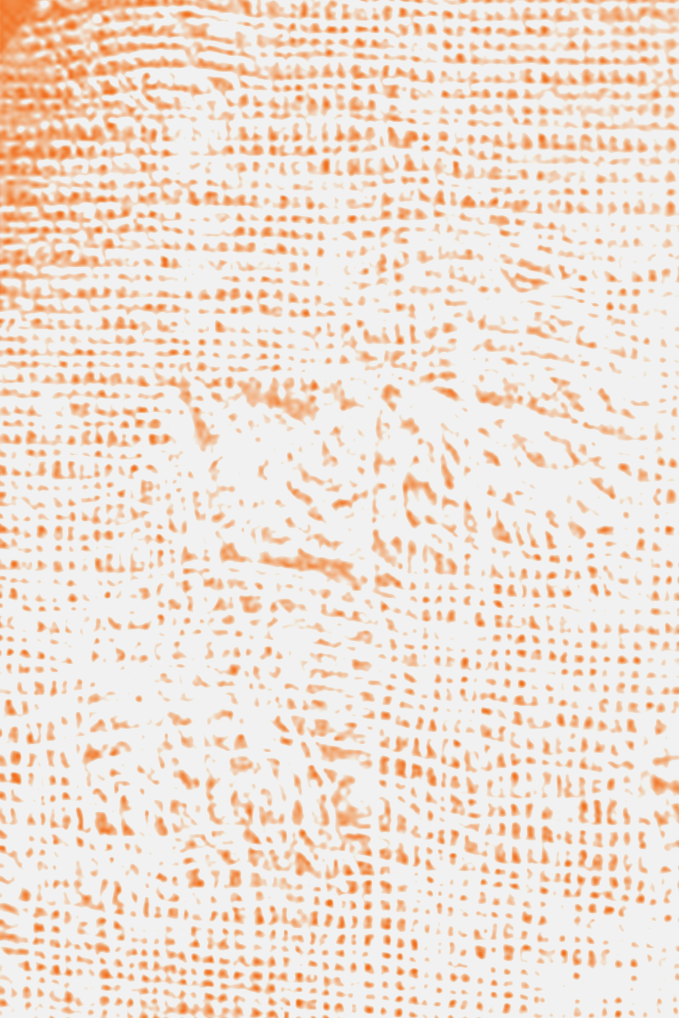 Close-up of knitted fabric in orange and white colors.