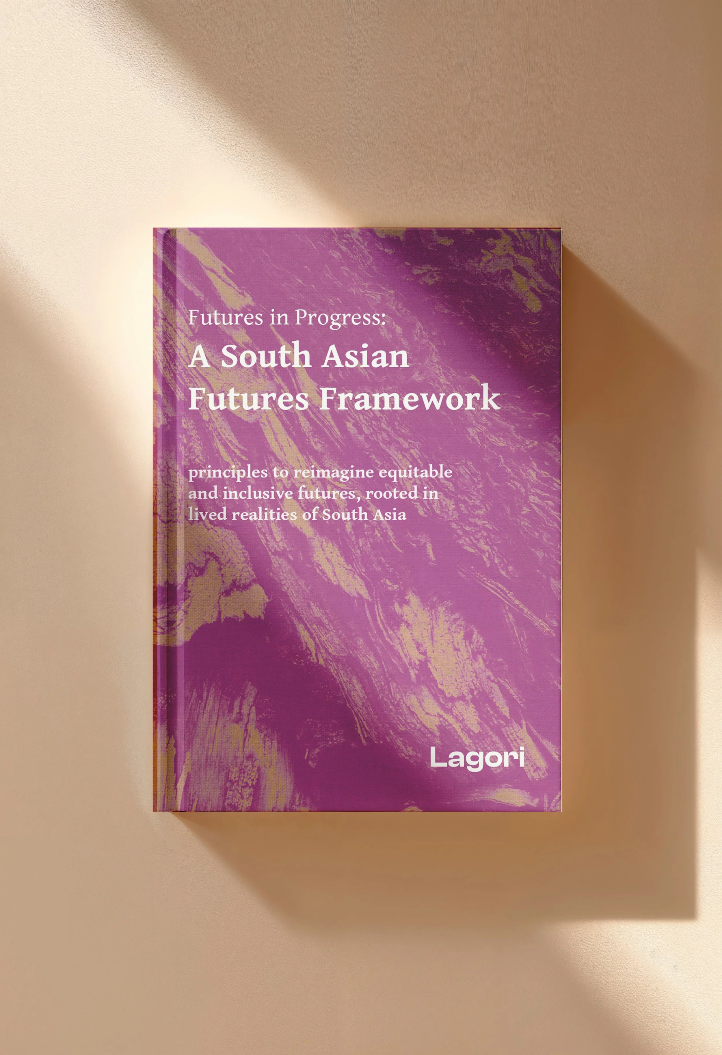 Cover of Futures in Progress: A South Asian Futures Framework, a publication by Lagori Collective offering principles for reimagining equitable and inclusive futures rooted in the lived realities of South Asia. Purple and gold textured hardcover.