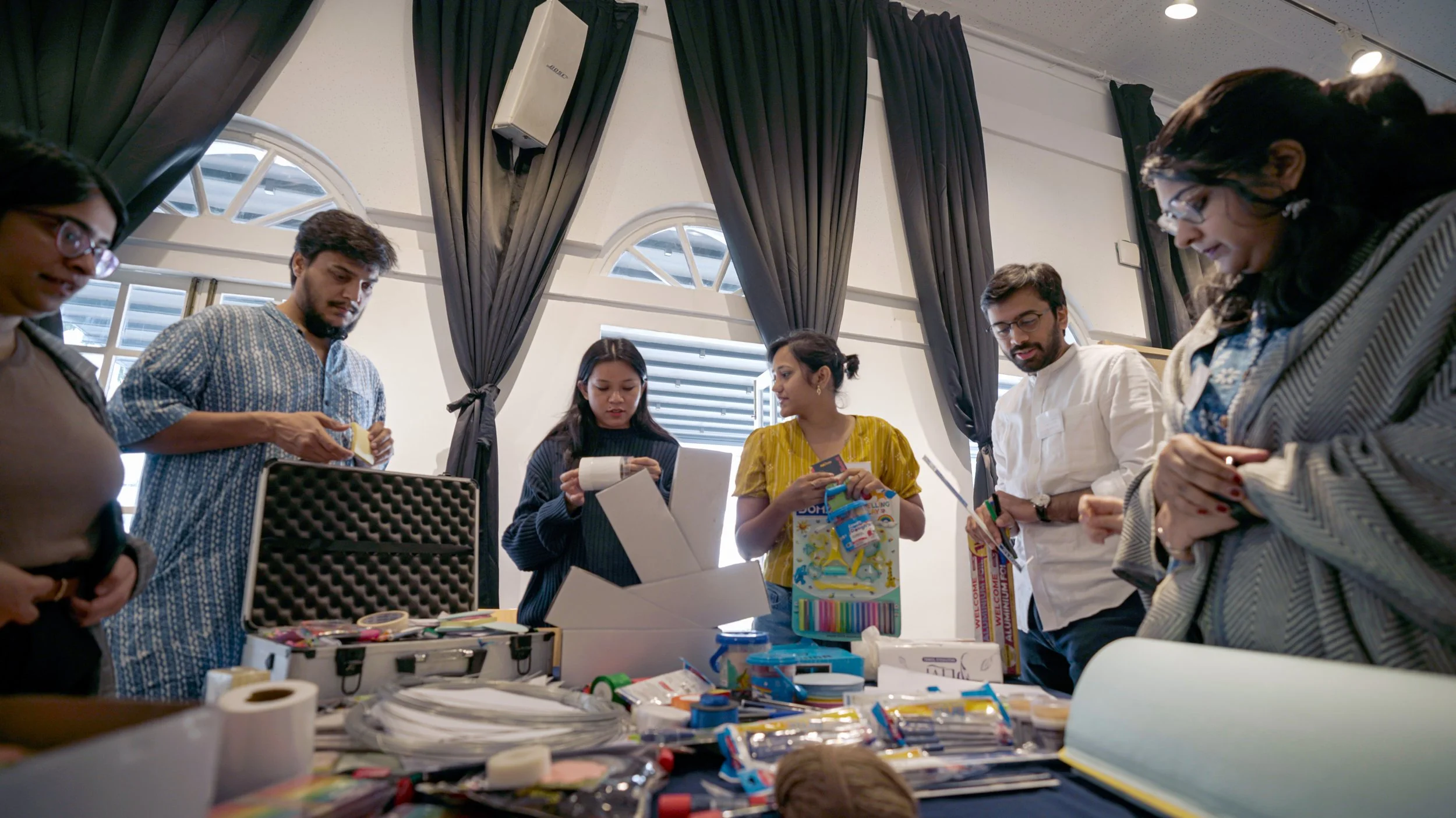 Participants building low-fidelity prototypes at a workshop table during Alternative Digital Futures, a participatory futures programme by Lagori Collective, Superrr Lab, and Goethe-Institut exploring alternative models for digital public spaces.