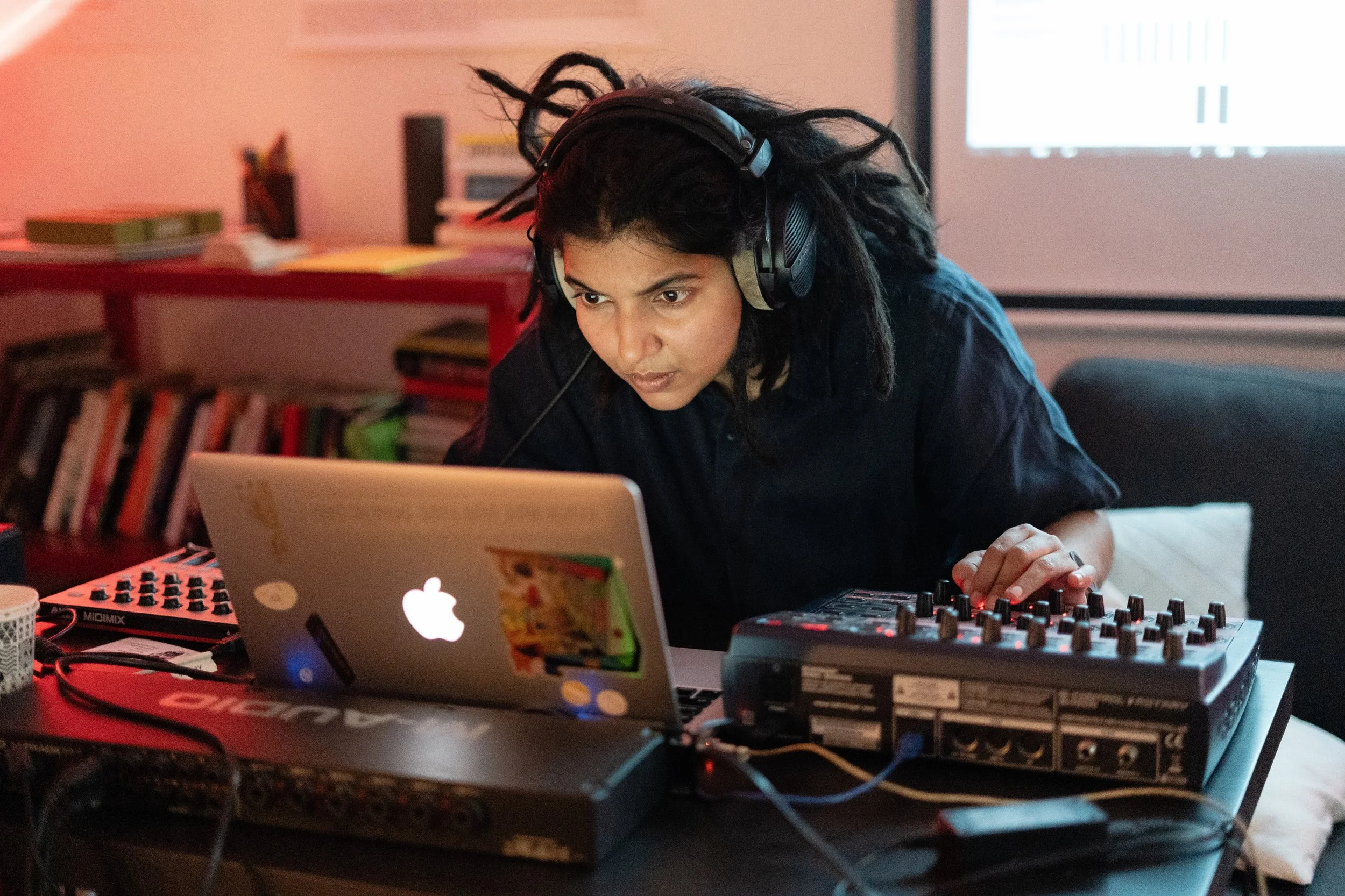 A game designer working at a laptop and audio mixer during research for Playgrounds of Power, a Lagori Collective and Goethe-Institut initiative on gender and digital game-making in India.