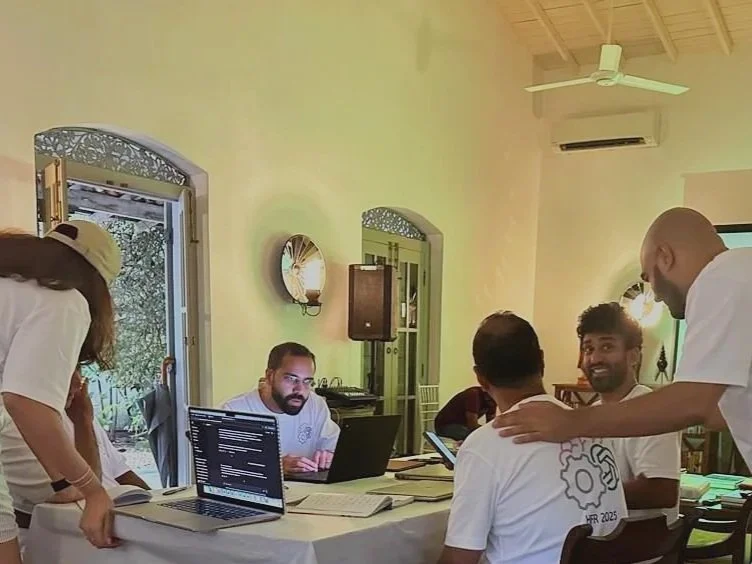 Participants working closely with laptops during a hands-on AI tools session at the Work. Life. AI. retreat facilitated by Lagori Collective for the Hemas family.