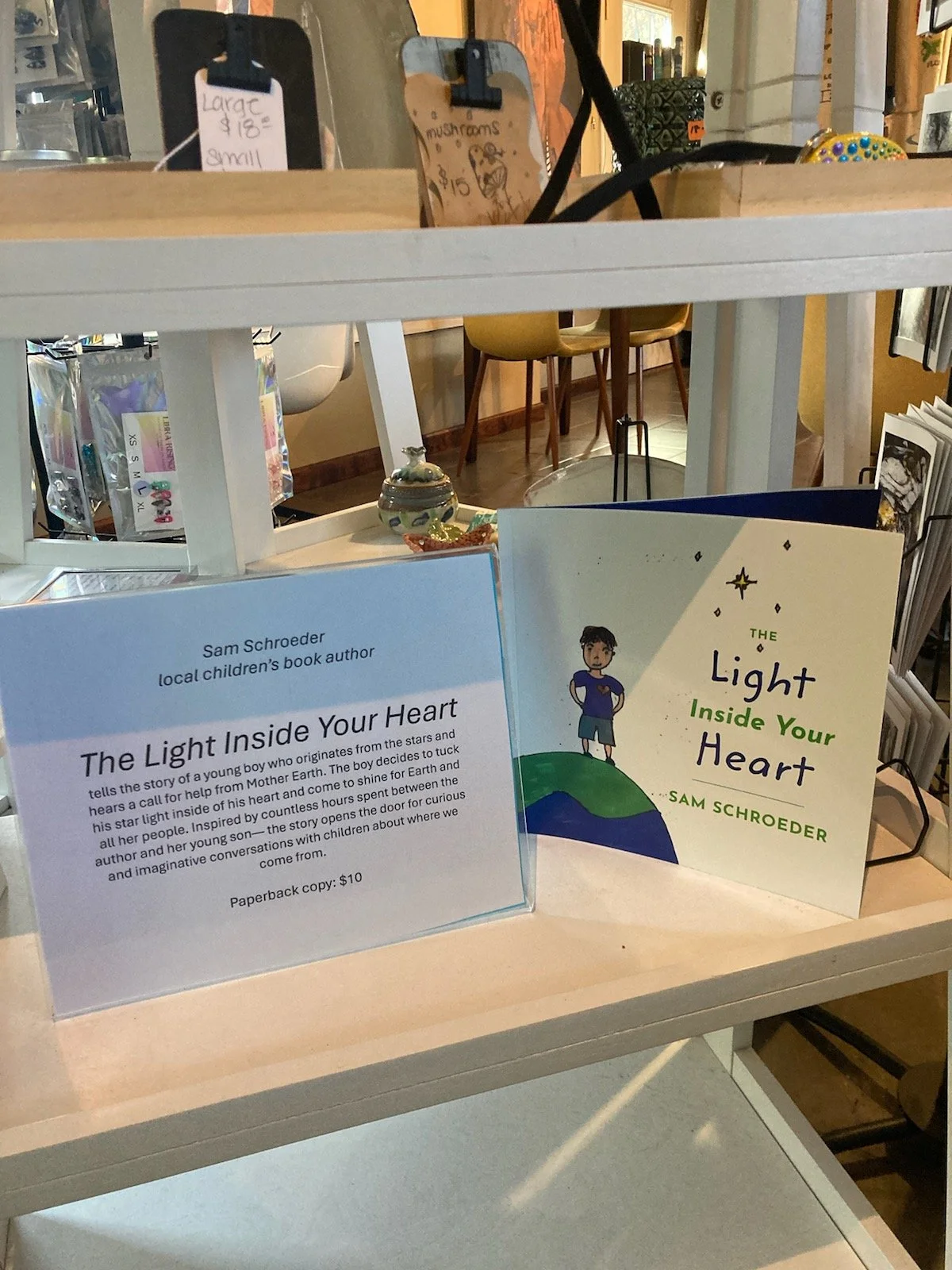 "The Light Inside Your Heart" children's book displayed on local coffee shop shelf