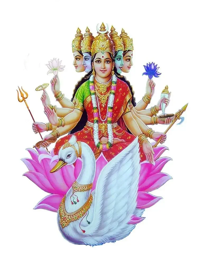 Hindu goddess Lakshmi with four arms, sitting on a pink lotus flower, holding lotus flowers and other symbolic items, with a white swan in front, depicted with crowns, jewelry, and traditional attire.