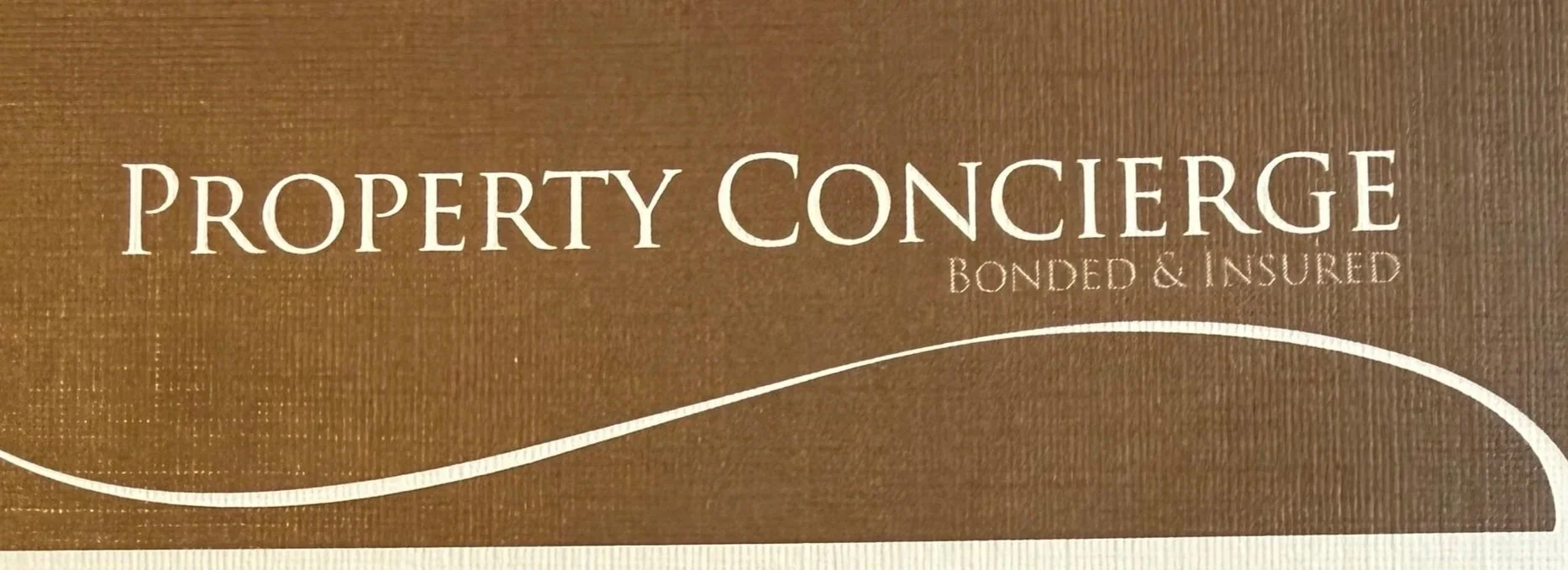 Sign with the words "Property Concierge Bonded & Insured" on a brown background.