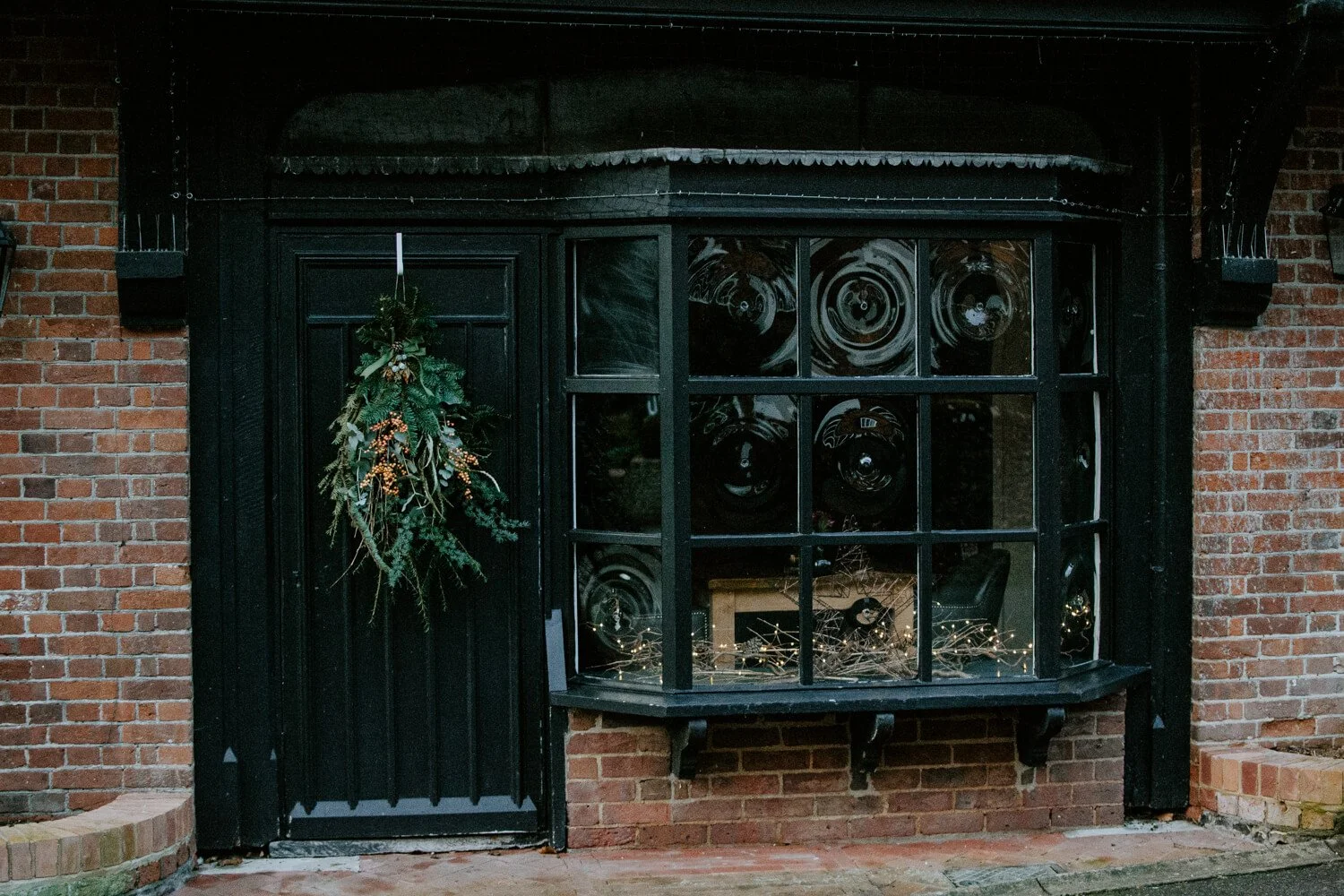 Christmas wreath on a black wooden door | A Wholesome Life | Josephine Brooks
