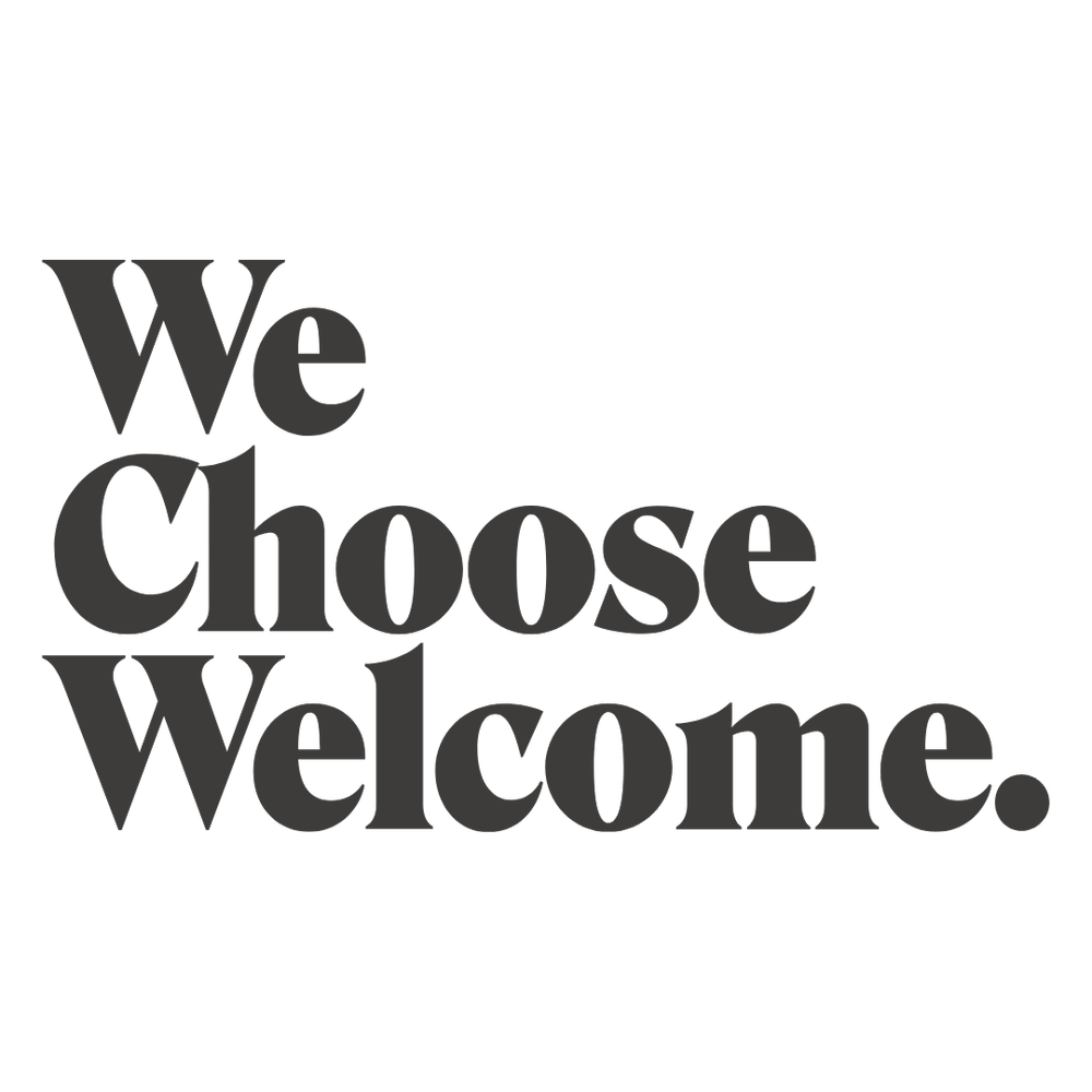 Black background with gray text that says "We Choose Welcome" in large, bold letters.