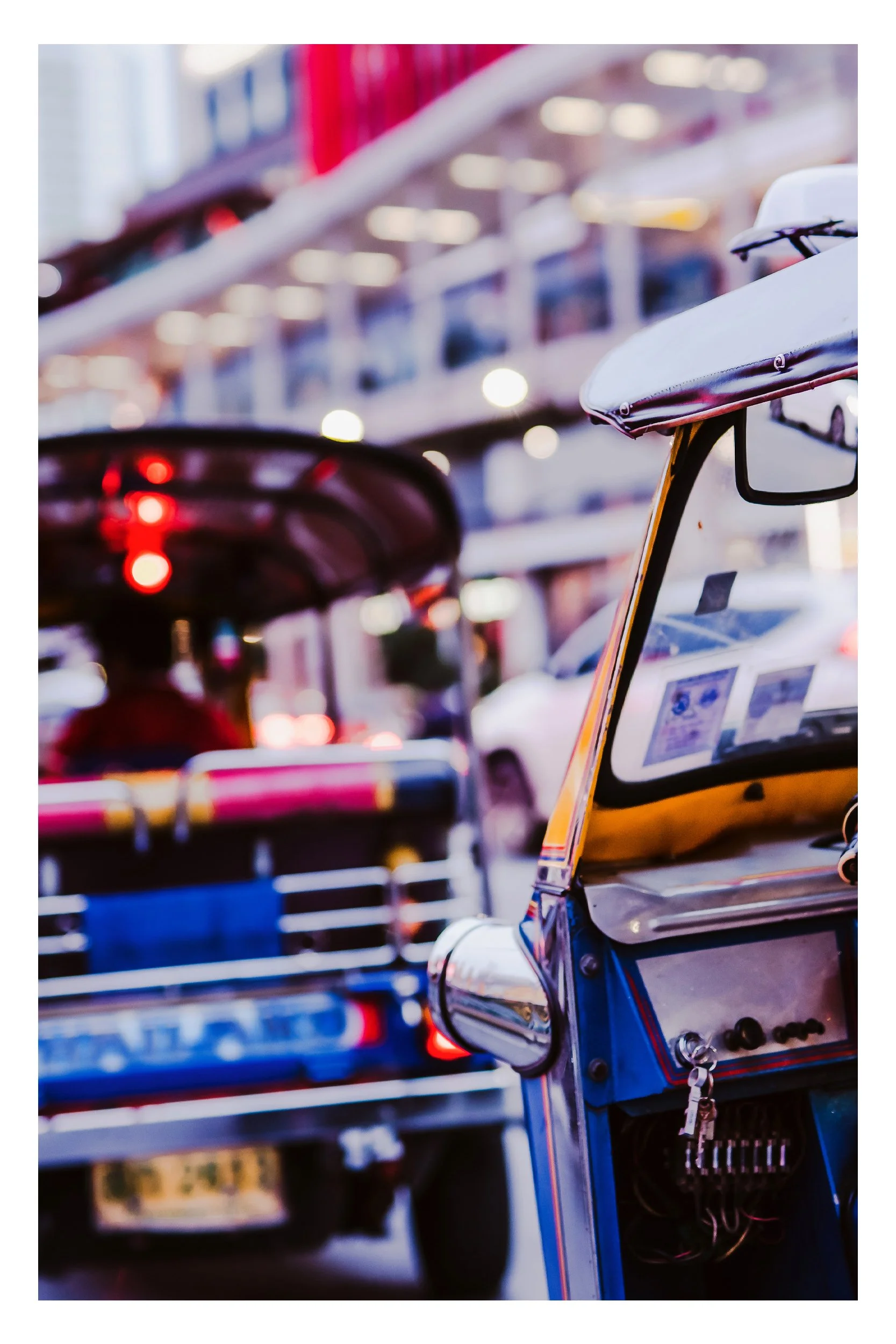 A colorful, traditional auto-rickshaw navigating a vibrant street in India, representing authentic local transportation and the energy of daily life.