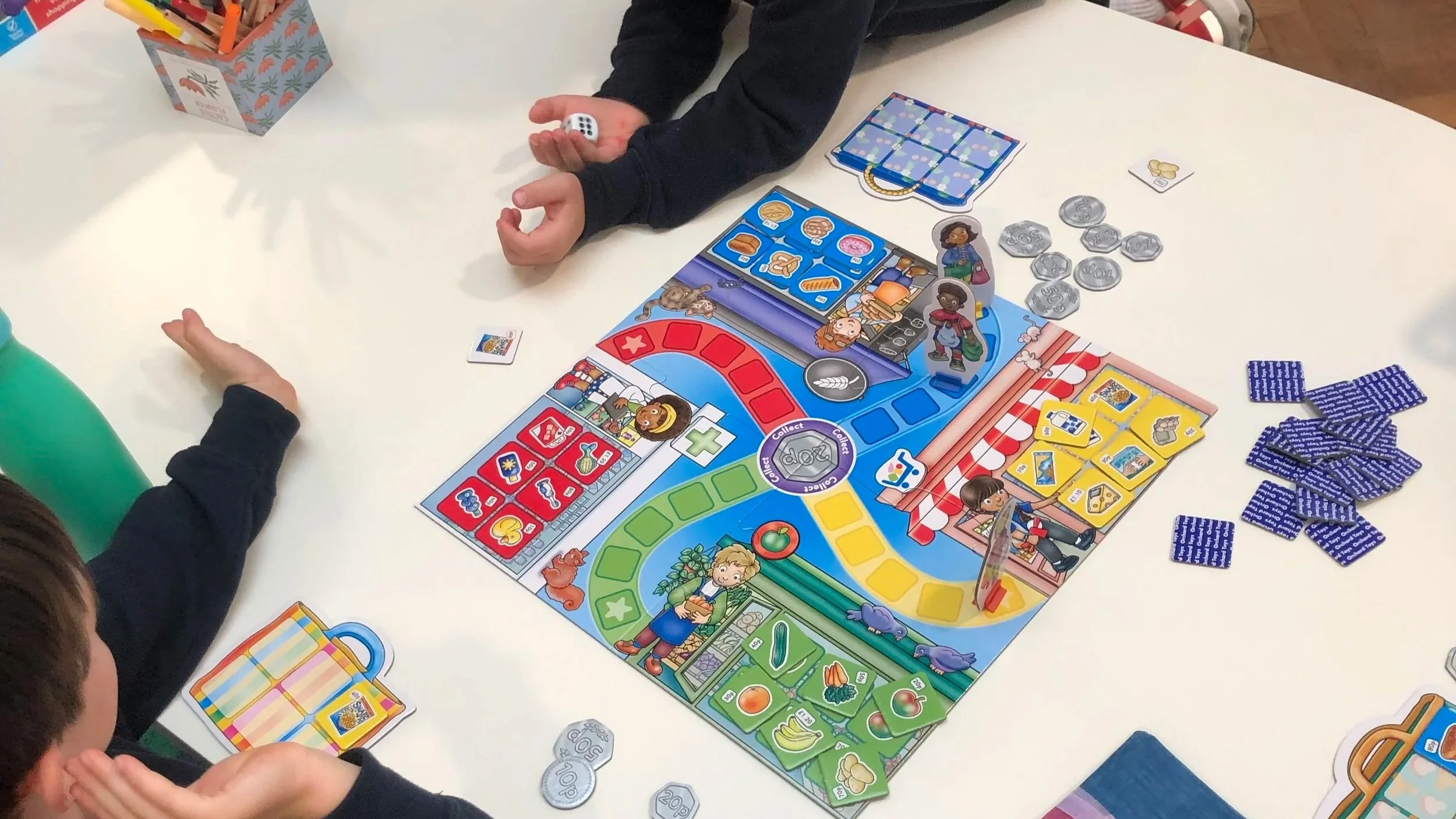 wo boys playing a maths board game together during a small group tutoring session at The Study Studio, Parsons Green Fulham