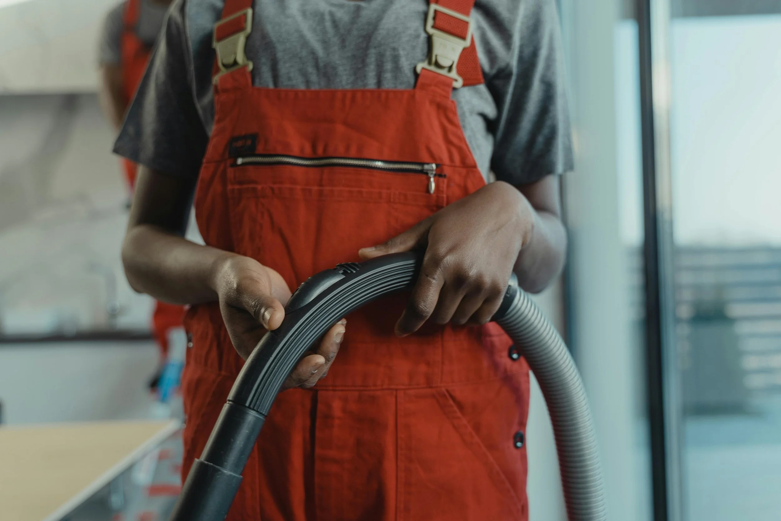 Professional cleaner holding a vacuum