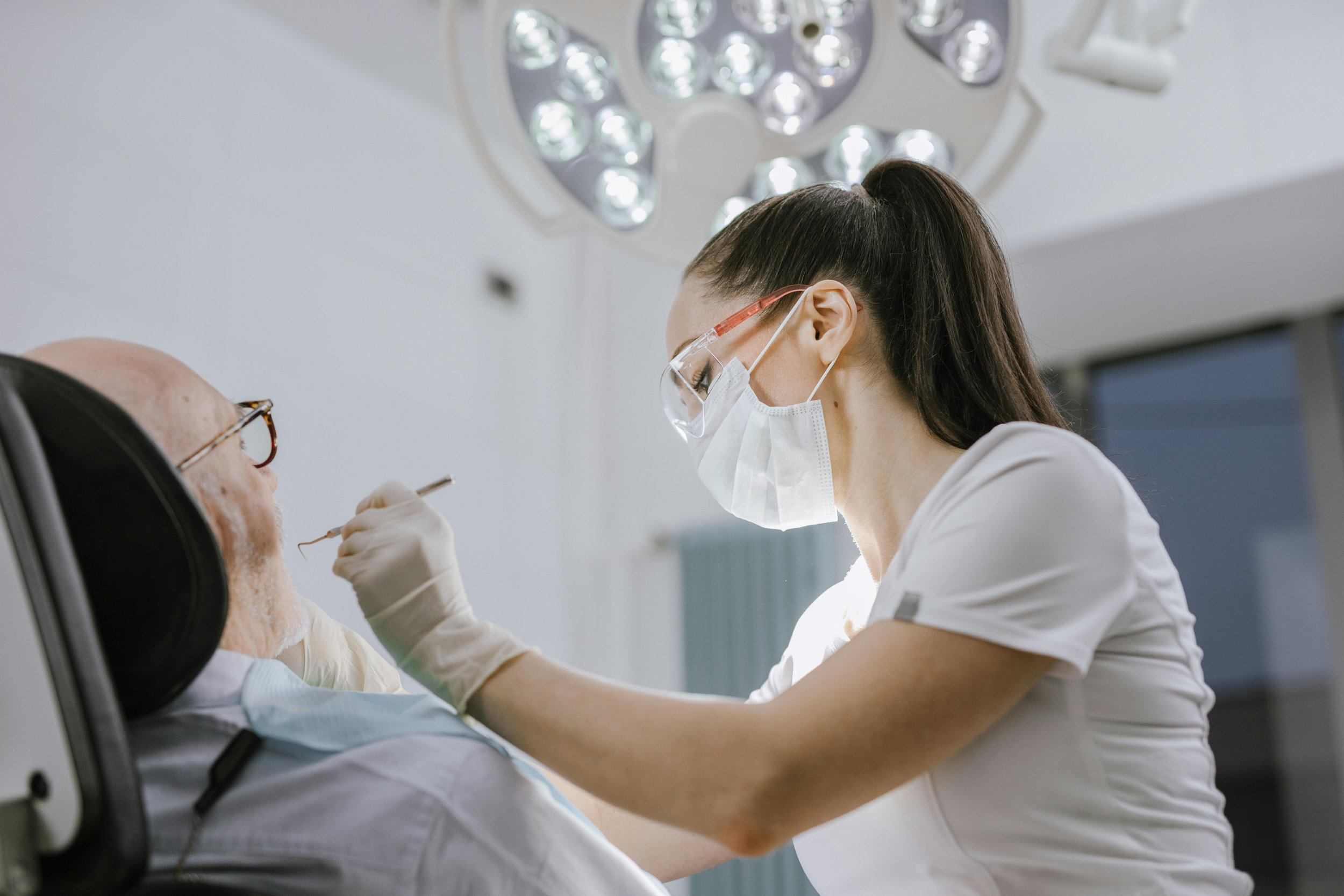 Dentist performing a dental procedure on a patient.
