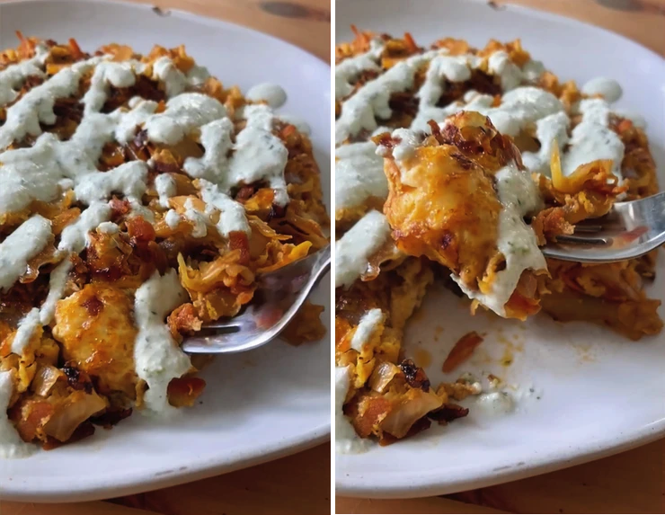a fork lifting gochujang scrambled eggs with cabbage, onions, and carrots topped with a cucumber yogurt dressing