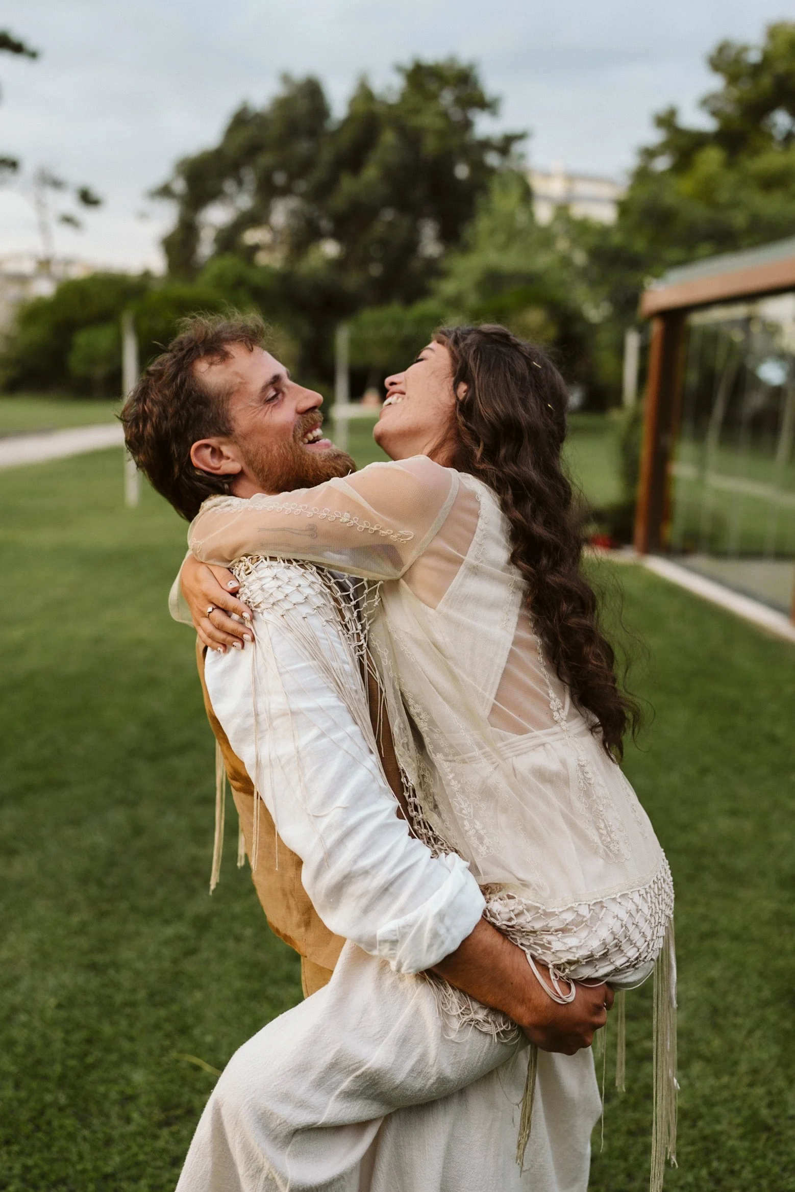 Happy couple hugging outdoors in a park.