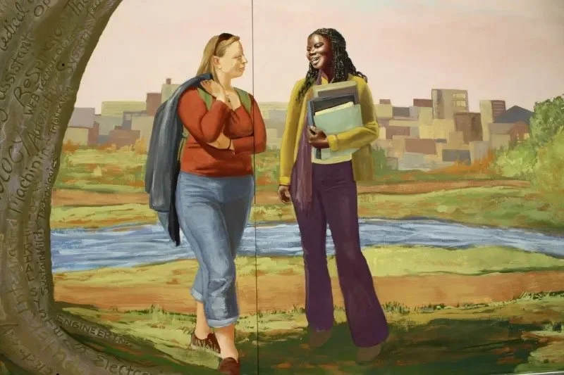 Painting of two women talking outdoors near a river, with an urban skyline in the background.