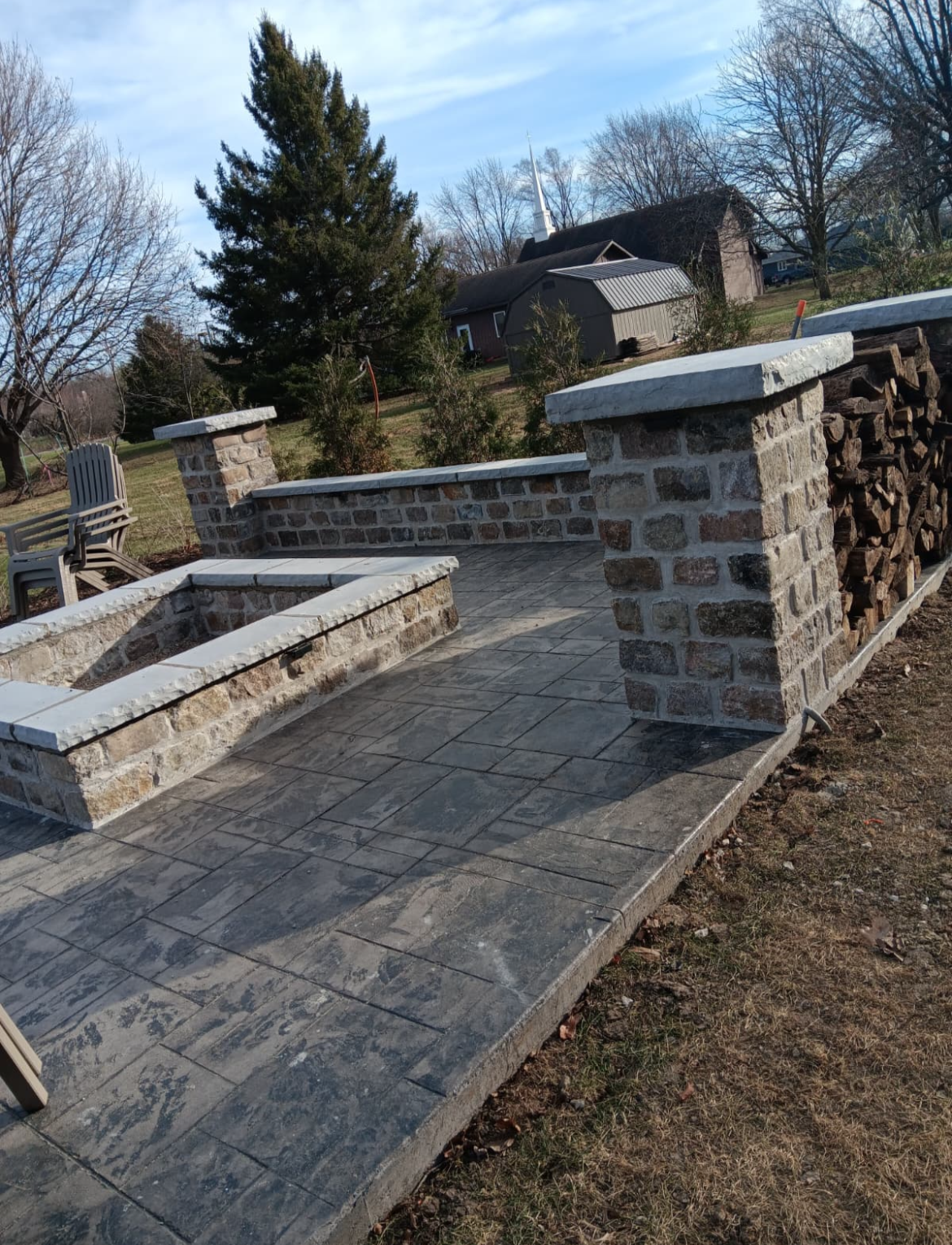 Outdoor paver patio with built-in fire pit in Elgin, IL designed for relaxation and gatherings