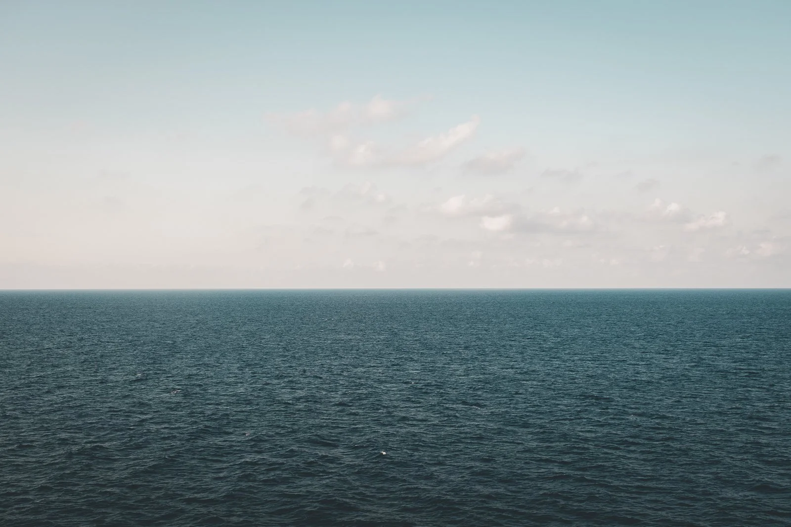 photo d'une mer calme avec un ciel nuageux