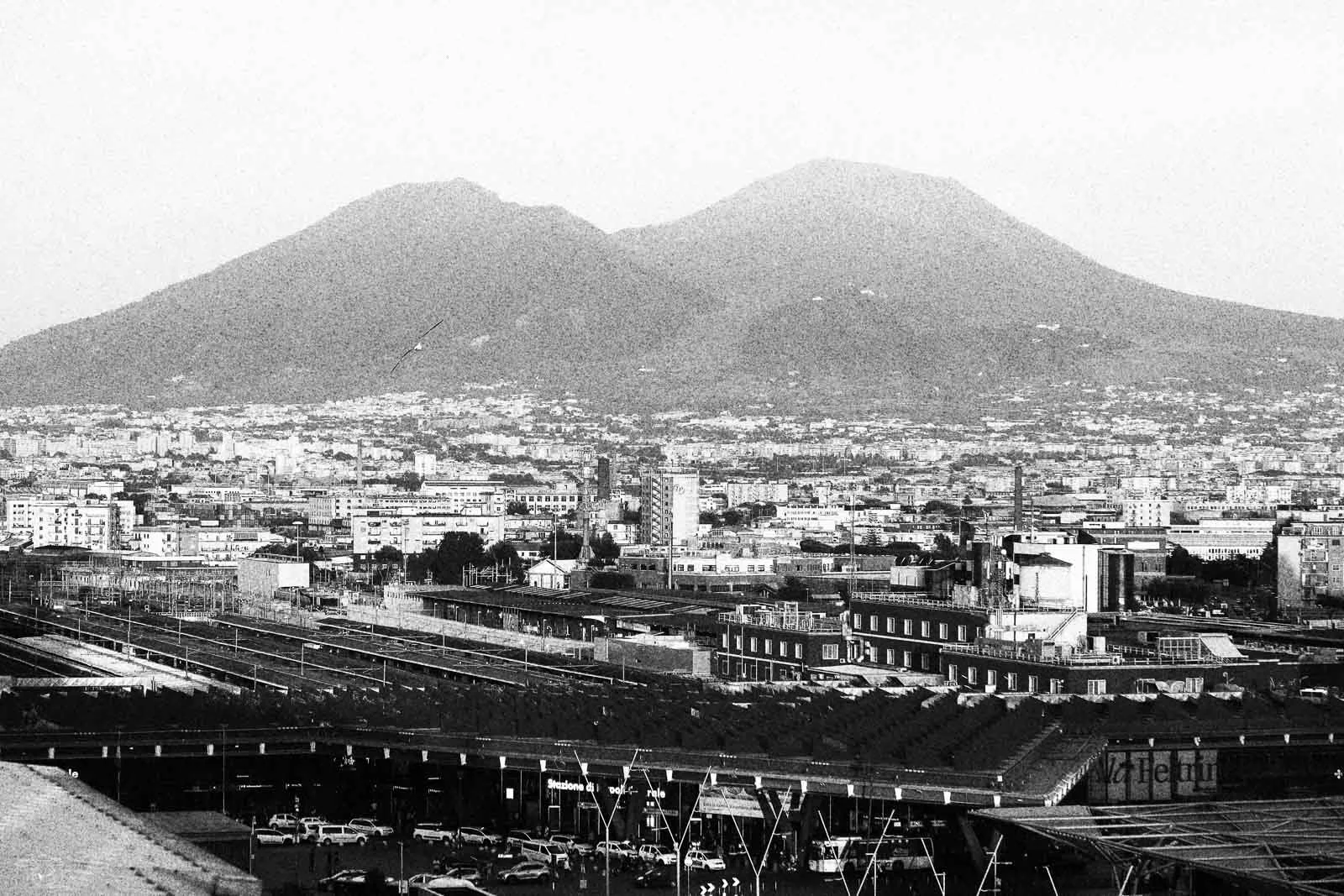 Une vue urbaine de Mexico avec deux volcans en arrière-plan et un centre-ville densément construit.