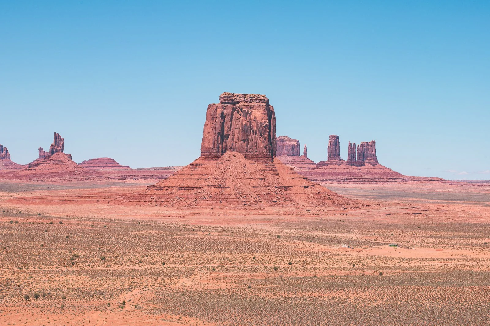Paysage désertique avec formations rocheuses monument Valley, ciel bleu clair.