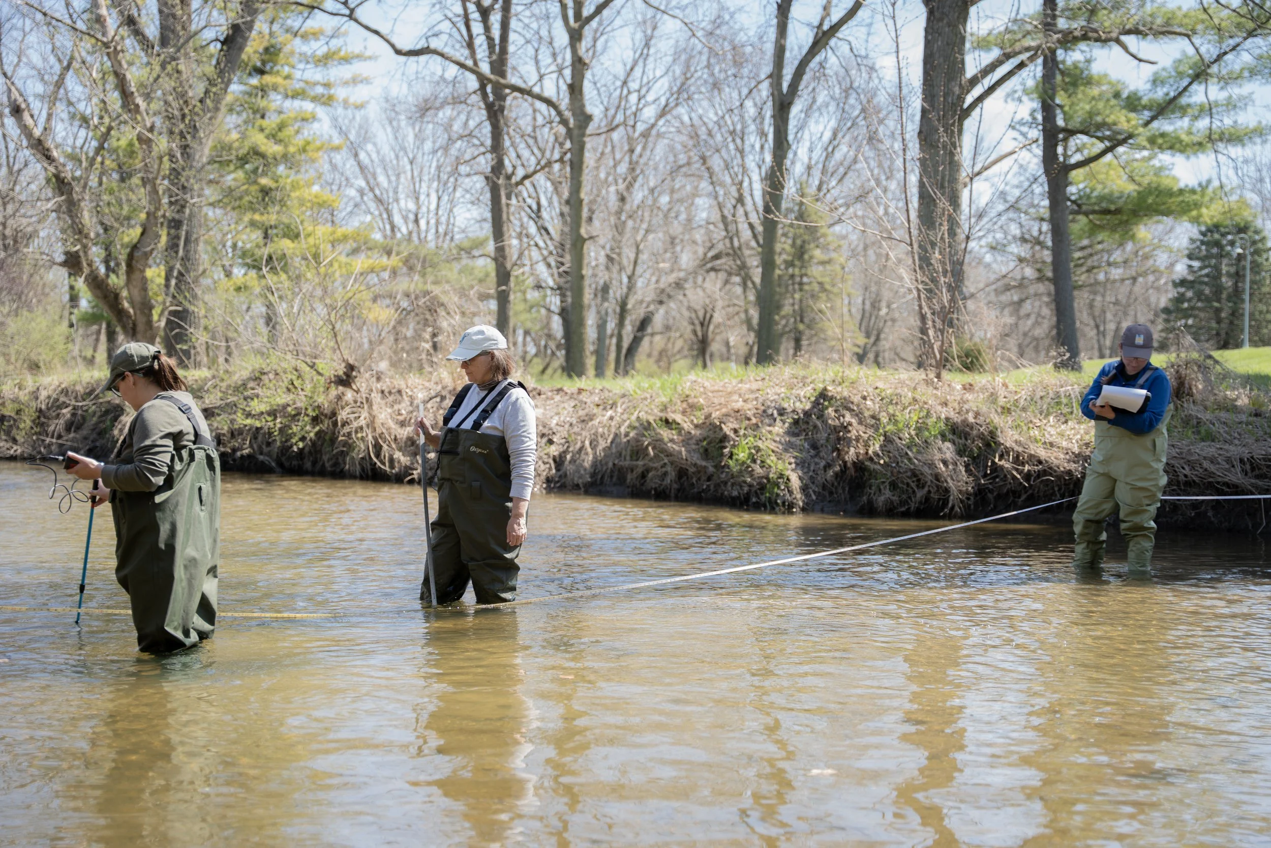 Theresa, Rebecca Rees and Kelly Brown set up to take water samples at Honey Creek on Sunday, March 29, in Martinsville, Ind. 
