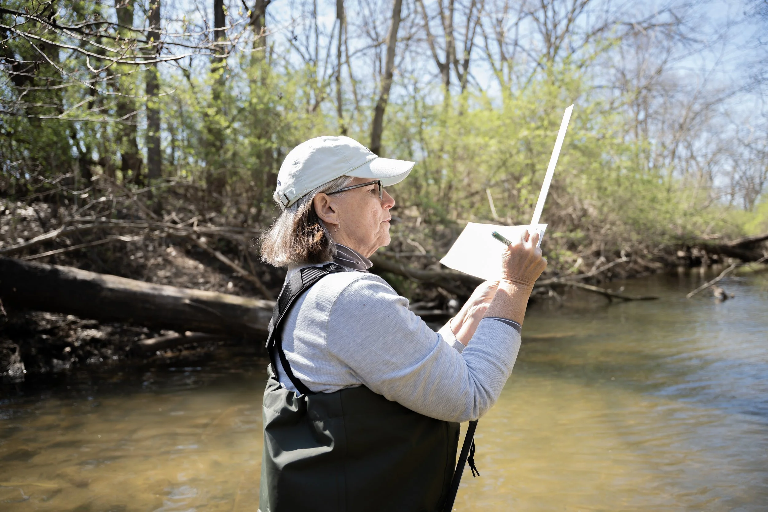 Rebecca Rees takes notes for water sample data gathered at Honey Creek on Sunday, March 29, in Martinsville, Ind.
