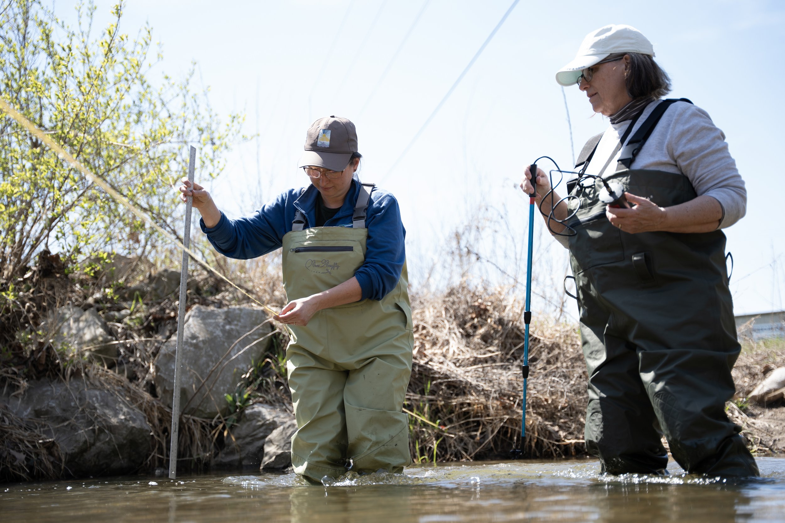Rebecca Rees and Kelly Brown test water flow at Honey Creek on Sunday, March 29, in Martinsville, Ind. 
