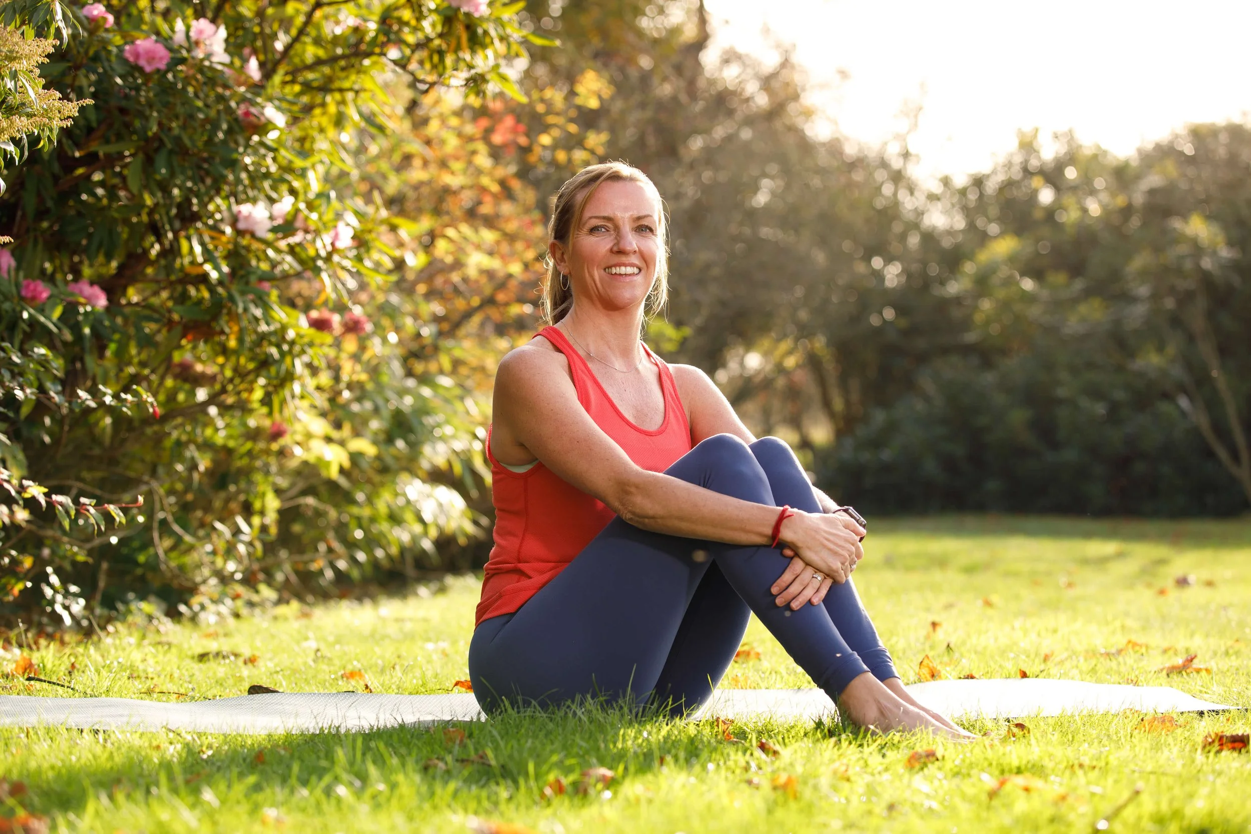 Louisa, founder at Move Well Studio smiles to camera wearing pilates clothing