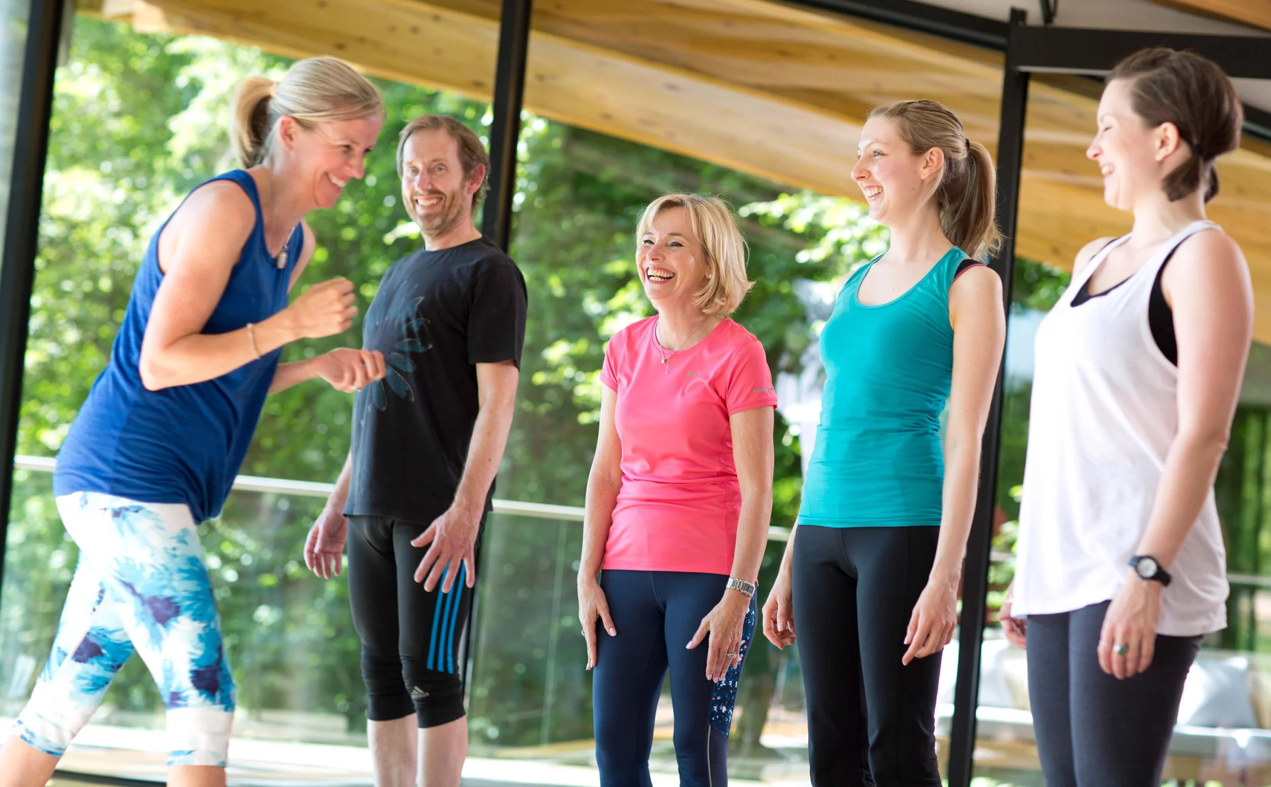 Louisa, founder at Move Well Studio smiling with a selection of students in a group yoga pilates class