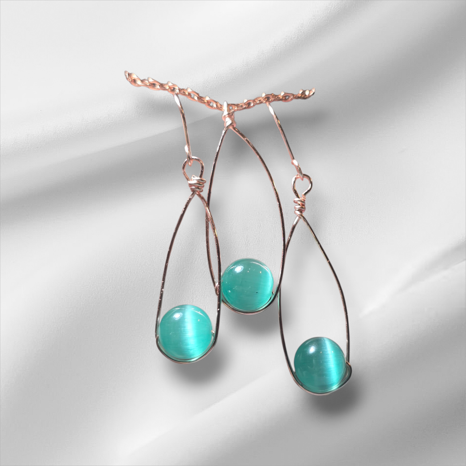 Rose gold set with green cat eye glass bead.