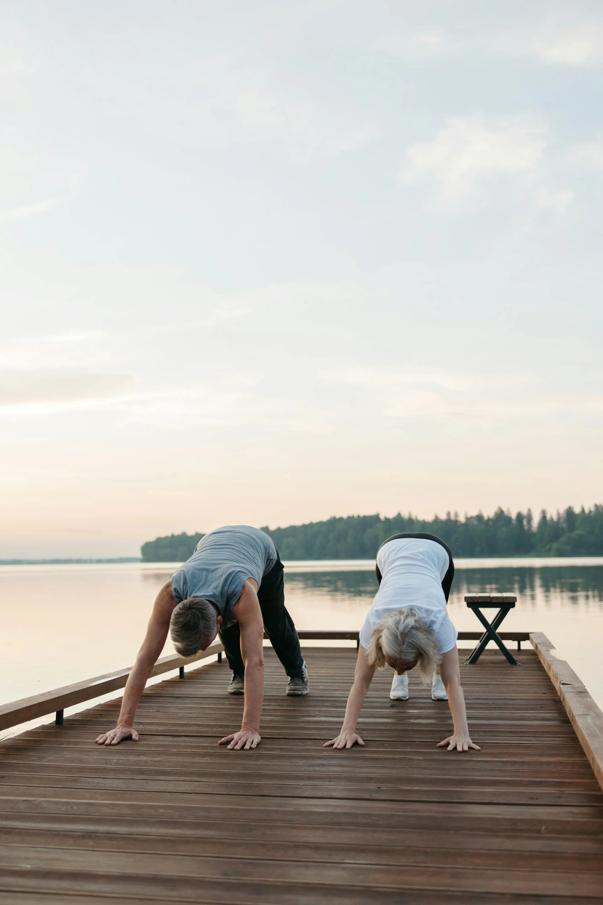 Two old women exercising on a deck