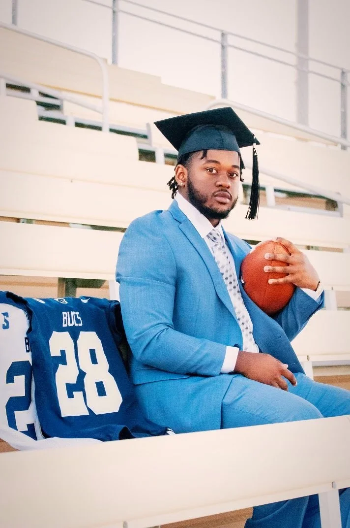 Dr. Markus Melvin holding a football