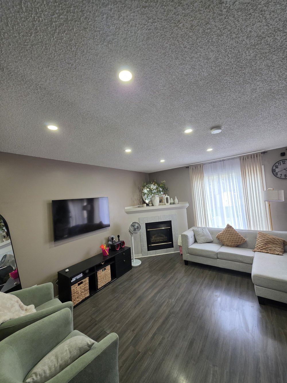 Warm white living room pot lights by the fireplace