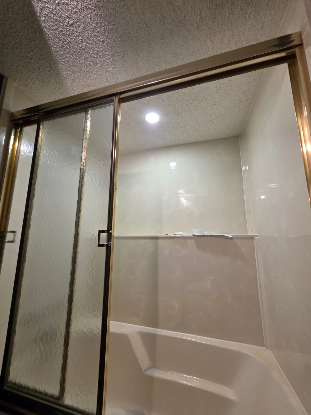 Wet-rated shower pot light installed in an Edmonton bathroom