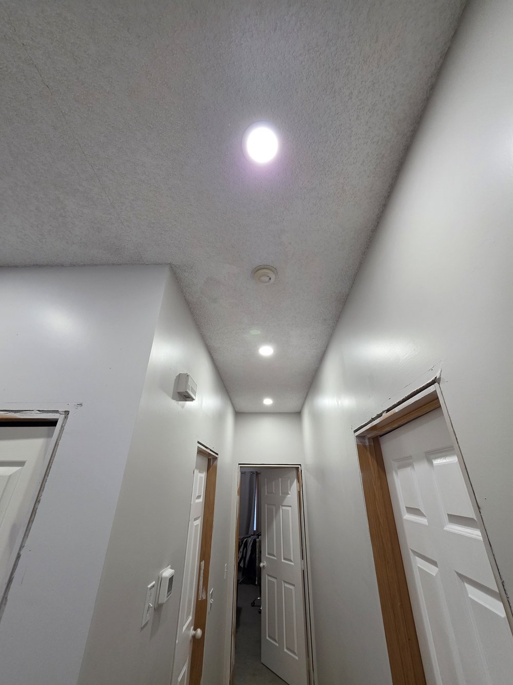 Upstairs hallway pot lights by Raylum Lighting