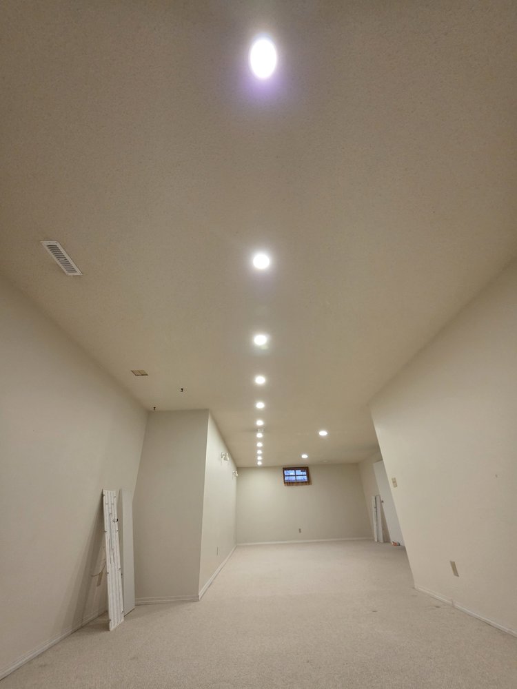 Long basement room with evenly spaced pot lights Edmonton