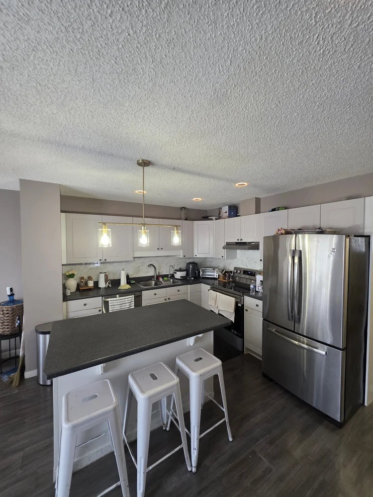 Pot lights over a white kitchen island in Edmonton
