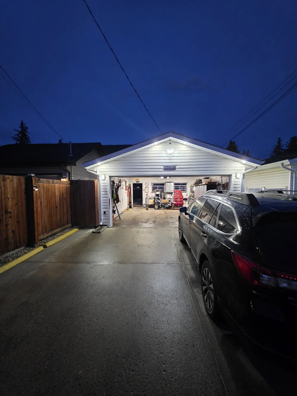 Garage soffit pot lights at night by Raylum Lighting