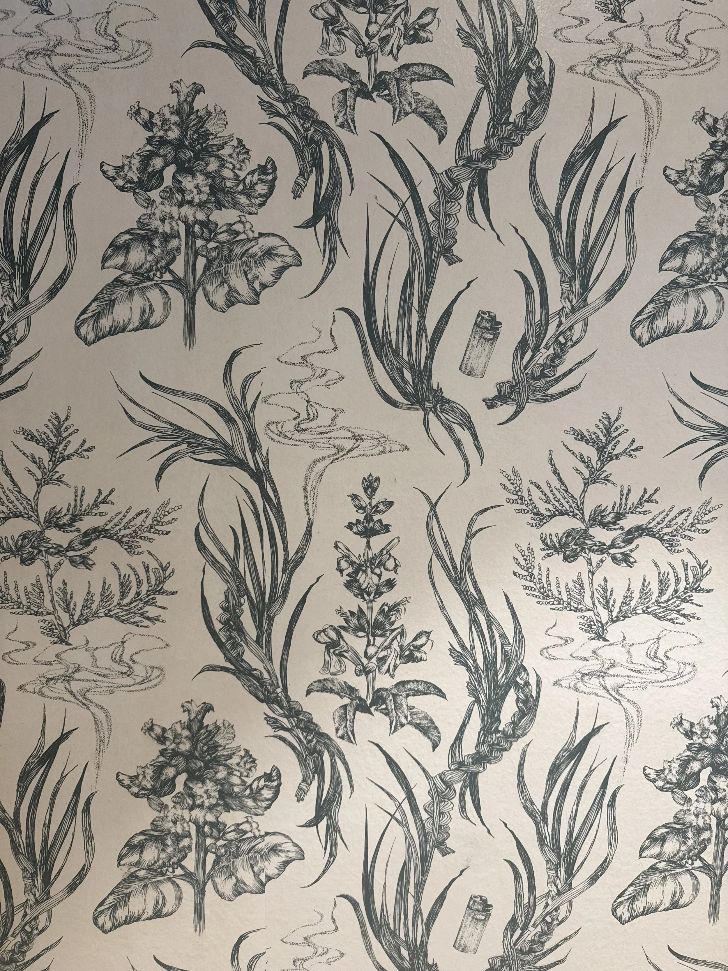 Black and white pattern featuring flowers, leaves, grass, clouds, and a lighter scattered throughout the design.