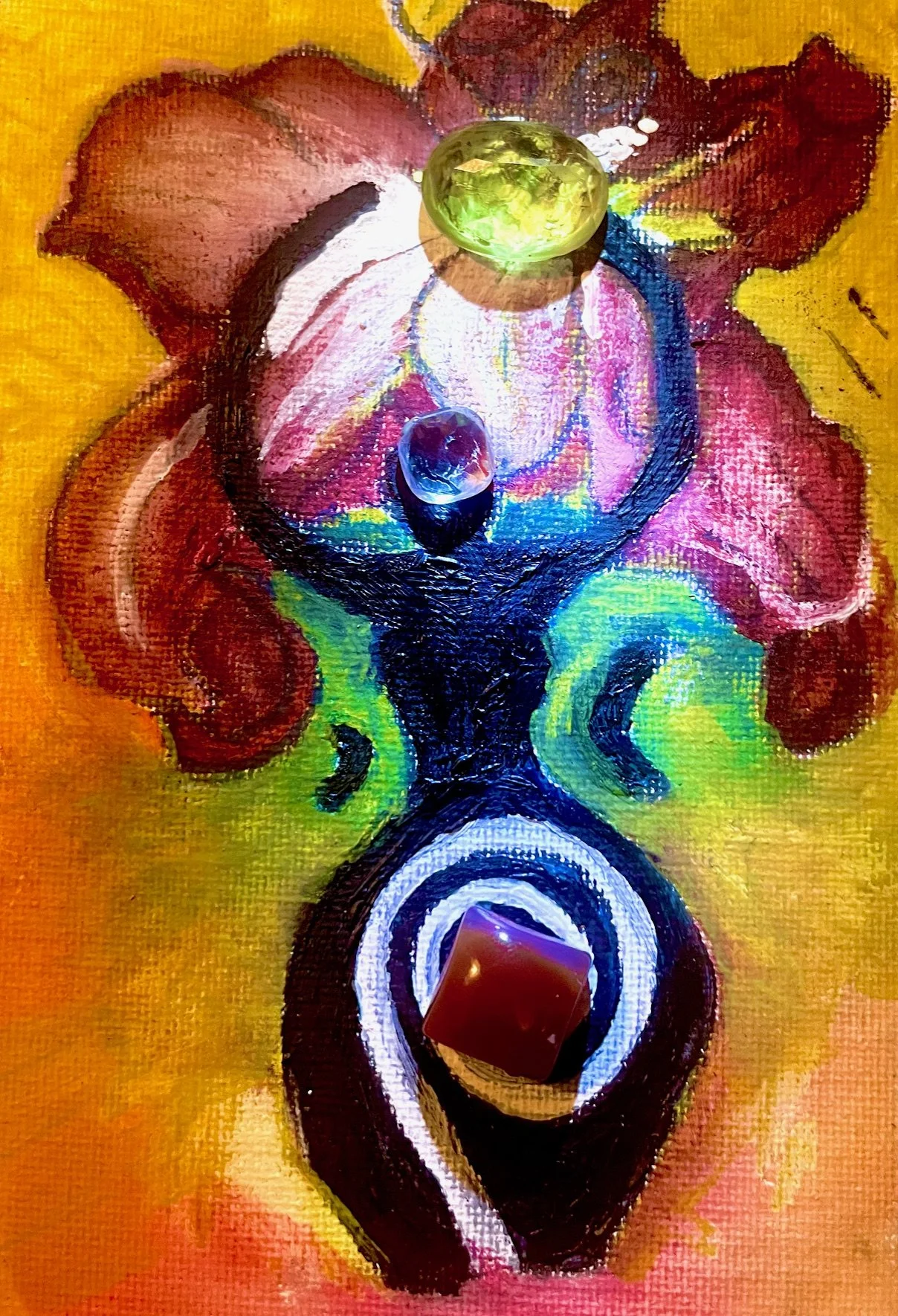 Colorful abstract painting with stones on it, including a large green stone at the top, a smaller purple stone, and a reddish-orange stone at the bottom.