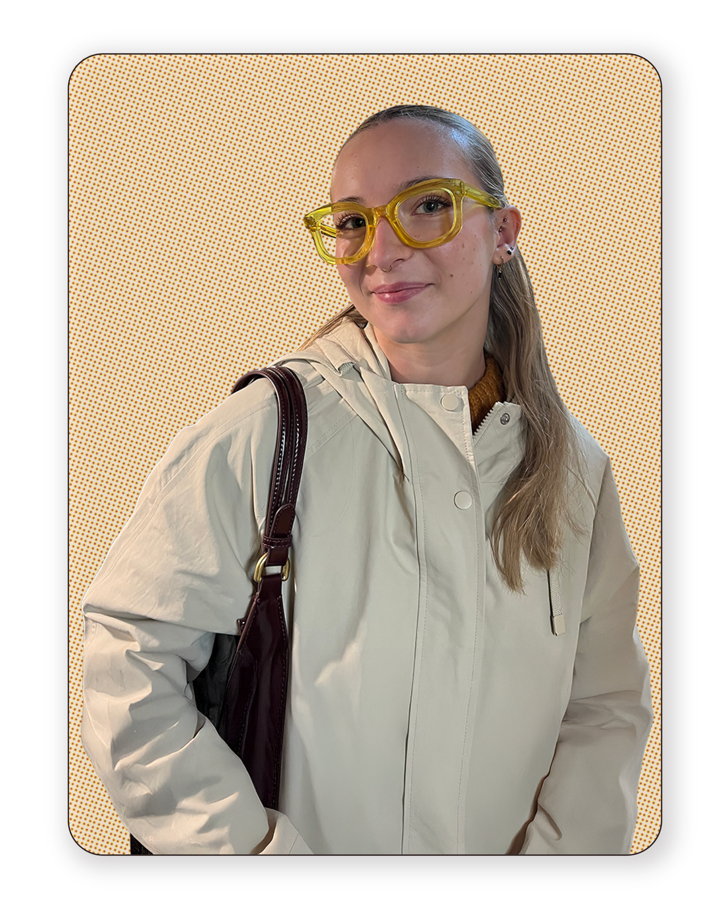 Young woman with yellow glasses, light beige jacket, and brown shoulder bag, standing against a yellow dotted background.