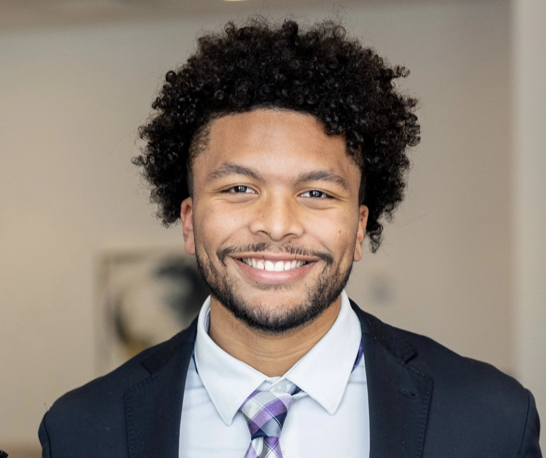 Tyson Ellison, award-winning journalist at the University of Missouri, smiles for his professional headshot during an NABJ Media Tour event.