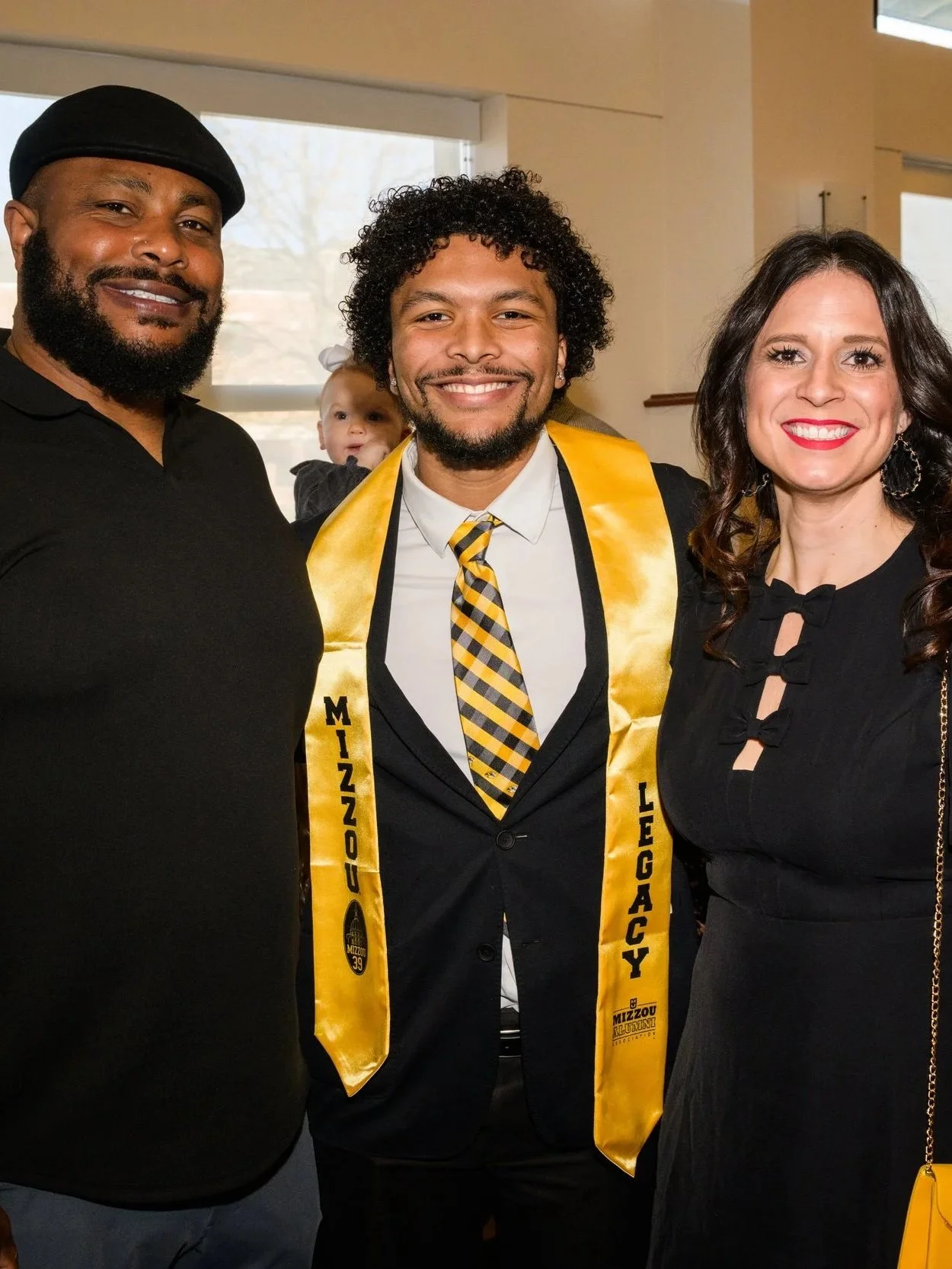 Mizzou Legacy student, Tyson Ellison, poses with his parents, 'Atiyyah Ellison and Jessica Ellison, as he accepts the Mizzou '39 Award, one of the most prominent recognitions a student can receive at the University of Missouri School of Journalism.