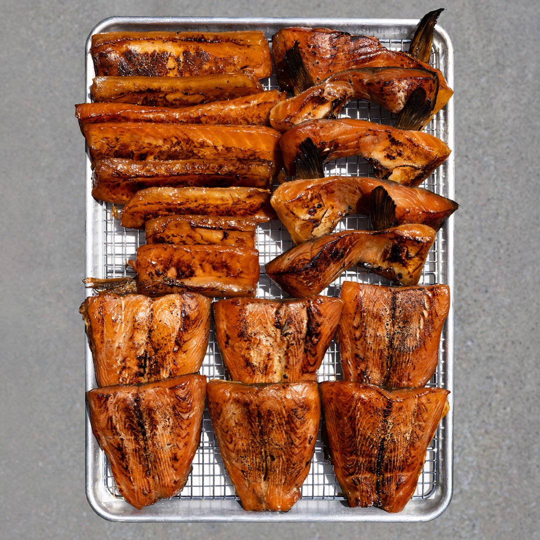 Roasted sweet potato wedges in a metal tray on a gray surface.