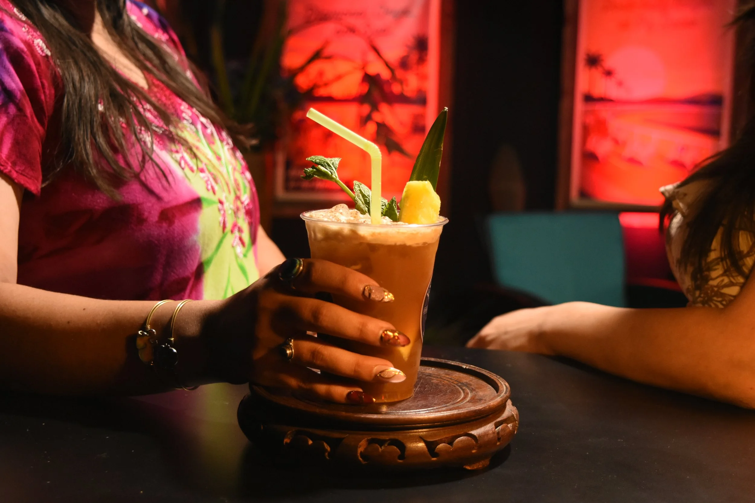 Tropical cocktail with mint and pineapple garnish.