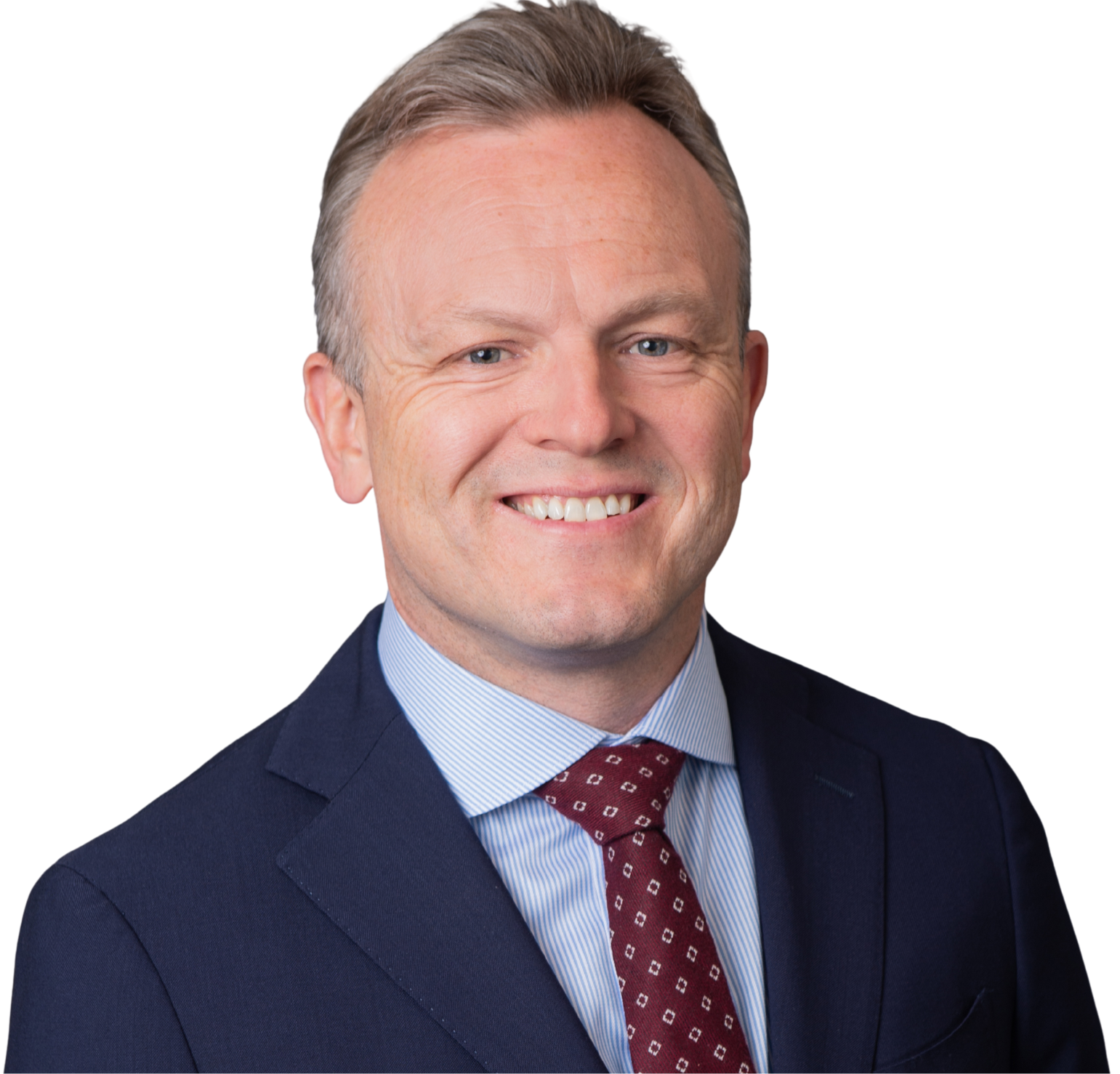 Professional headshot of a smiling man with light-colored hair, wearing a navy suit, light blue dress shirt, and maroon tie with white patterns.