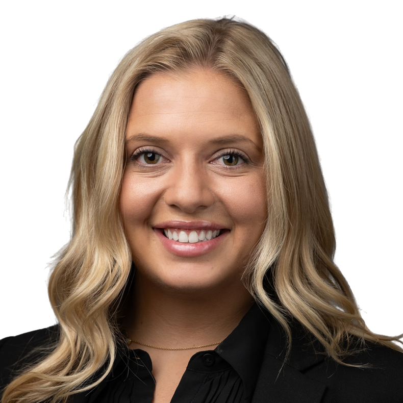 A smiling woman with blonde hair, wearing a black blazer, against a background with yellow and black elements.