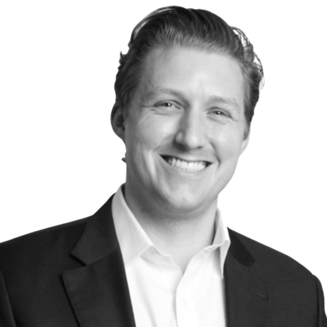 A smiling man in a suit with a background of a gold-colored signature or logo.