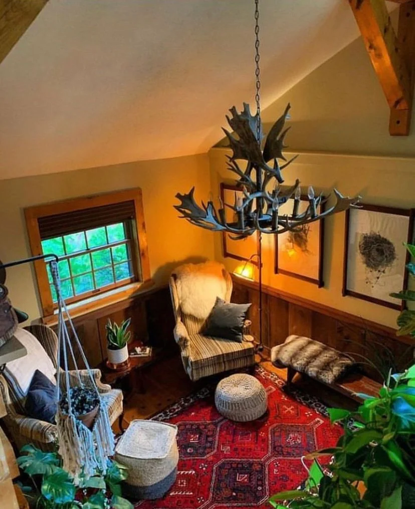 The reading nook below, framed by the antler chandelier overhead.