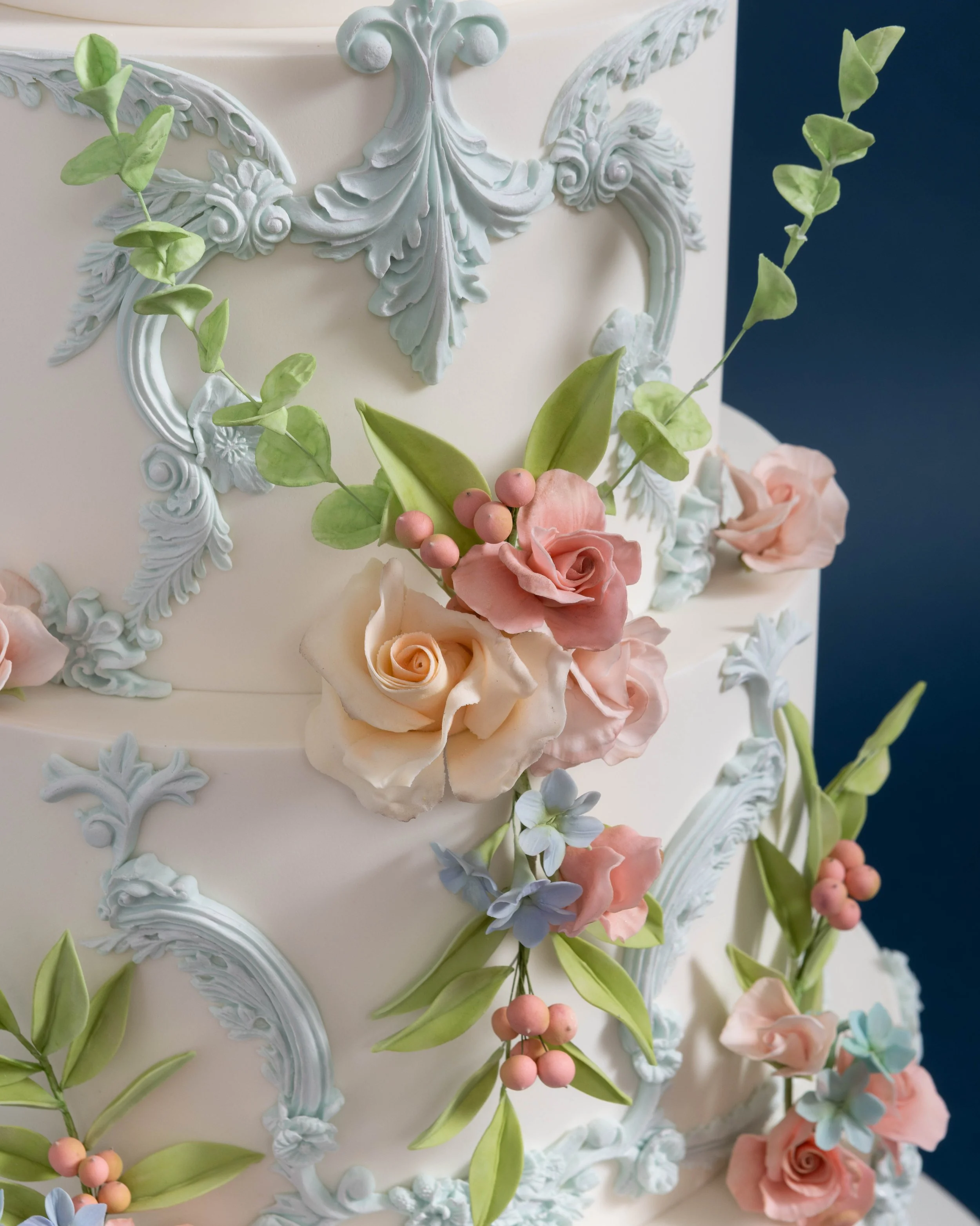 Detail of Rococo Bas Relief and Mini Roses Wedding Cake 